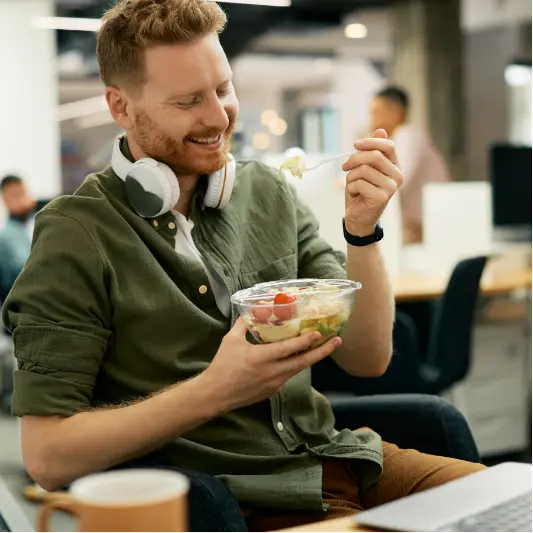 happy-businessman-eating-salad-on-lunch-break-in-t-2024-12-13-19-05-43-utc