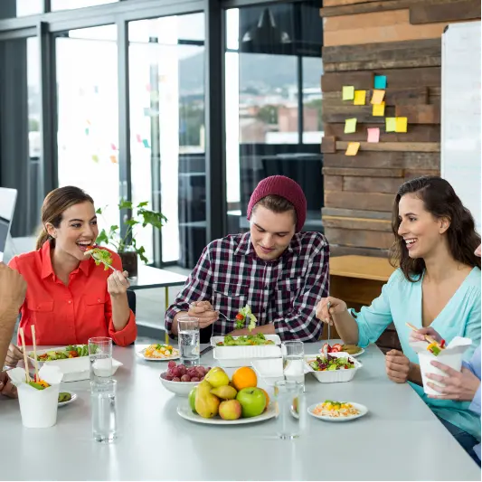 smiling-business-executives-having-meal-in-office-2025-04-05-06-04-55-utc